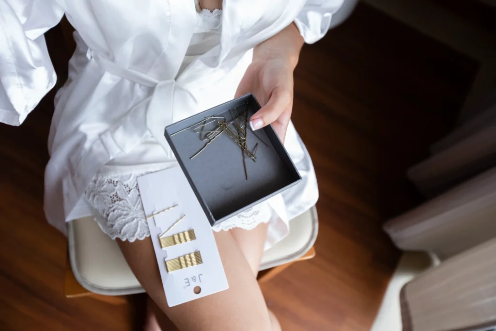 Hotel guest preparing for stay with hair accessories in a modern room