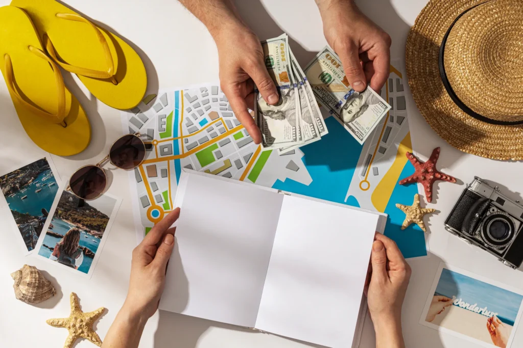 Hands holding cash and travel map while planning affordable off-season trips.