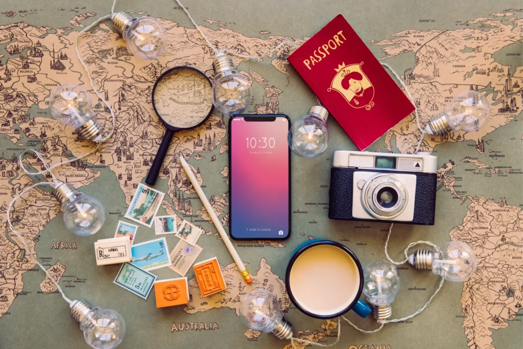 Digital tools for travel planning including smartphone, passport, and global destinations map