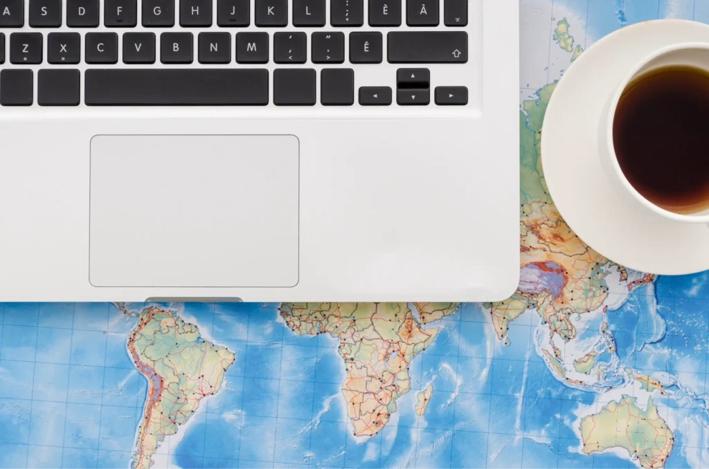 Travel website planning with global destinations map and laptop