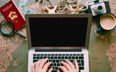 Travel content creation setup with laptop and global map for storytelling inspiration